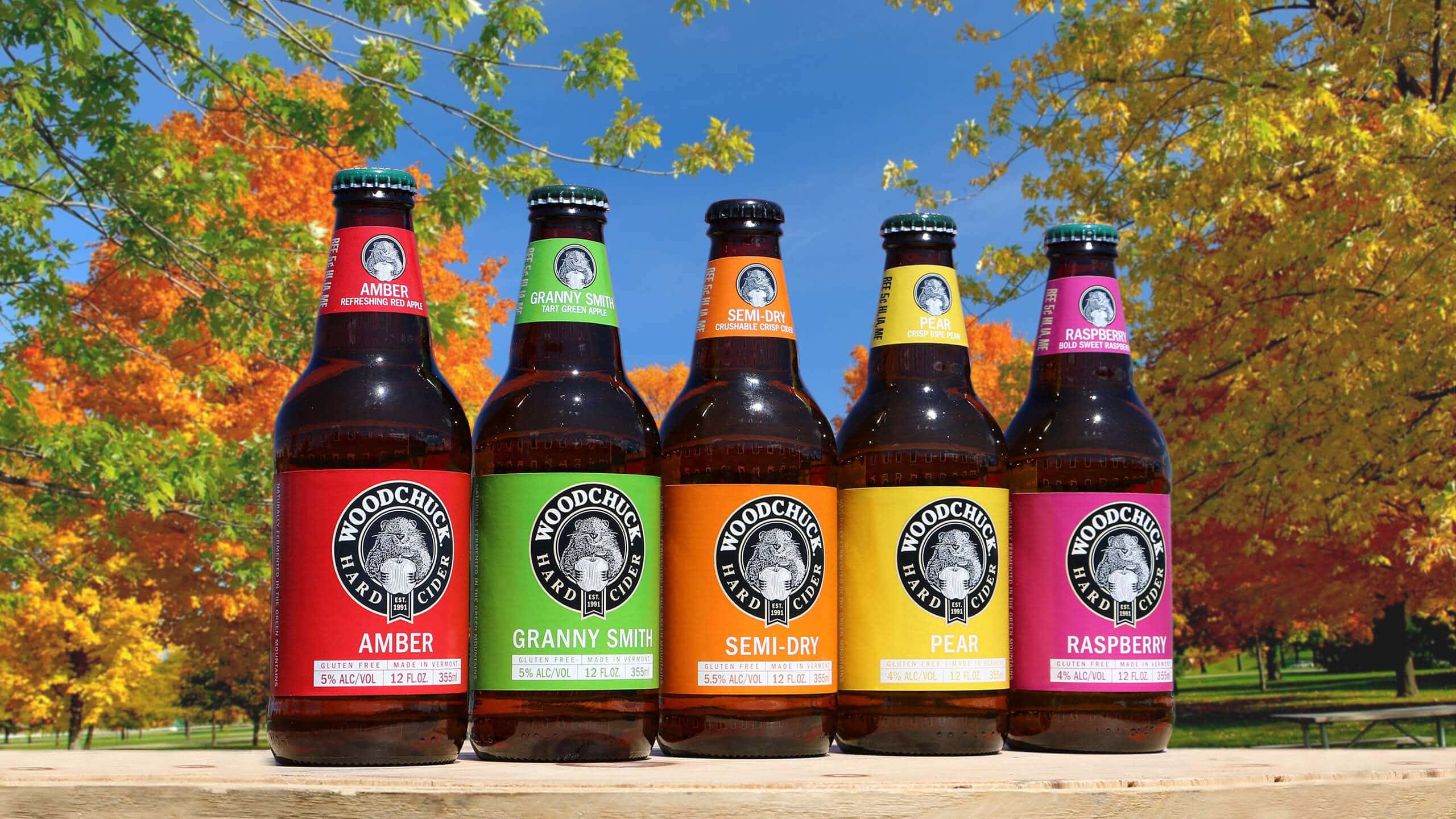 Woodchuck Hard Cider product lineup pictured outdoors with trees