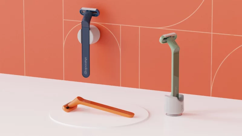 Shaveology green navy and orange shaving razors in razor stand