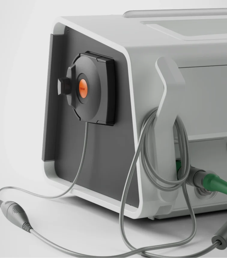 Rear view of a Sentec patient monitoring device showing the mounted sensor dock, cable management hook, and connected medical cables and ports.